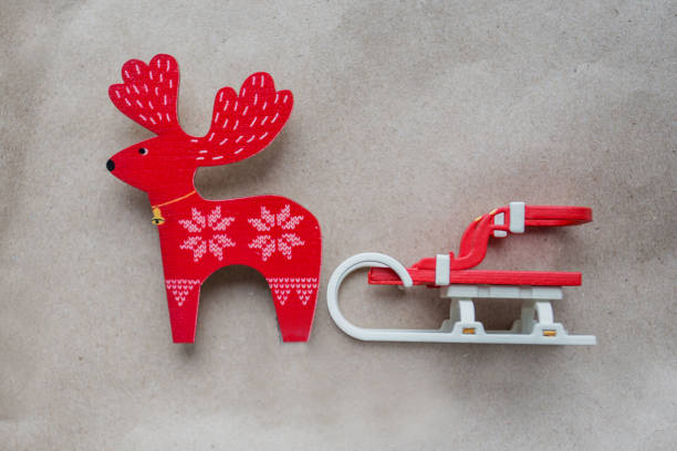 istock Christmas sleigh with red deer on craft paper. toy. 1283670182