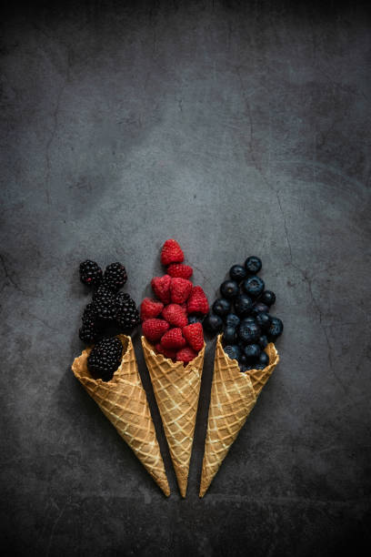 istock Fresh berries in waffle cones on dark stone background 1283671798