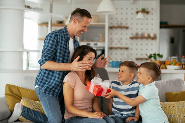 istock Two young sons are giving their mother a gift. 1283671886