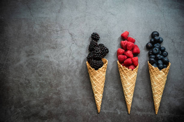 istock Fresh berries in waffle cones on dark stone background 1283671923