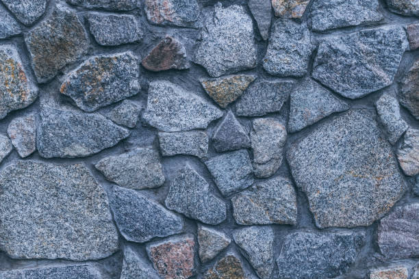 istock Vintage texture of stonework old masonry. Granite Cobblestone Wall 1283671979