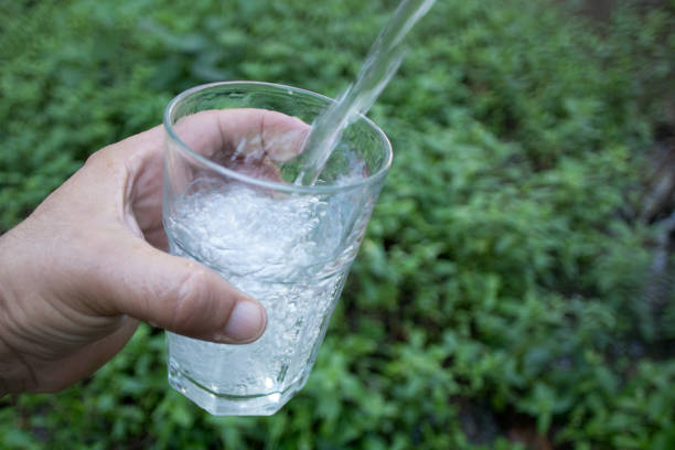 istock hand holding glass of water 1283672156