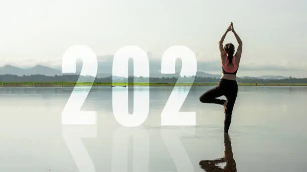 Photo of Happy new year start up 2021.  Yoga women lifestyle exercise and pose for healthy life. people balance body vital zen and meditation for workout sunrise morning nature background for success 2012. Health care Concept