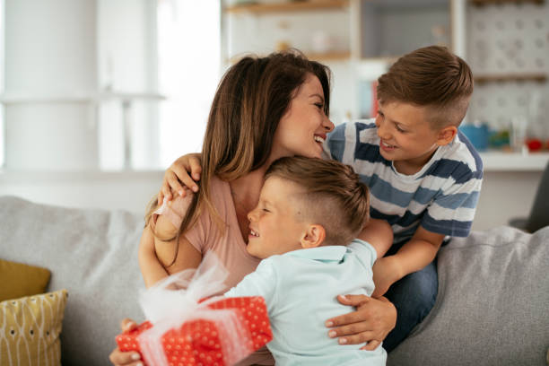 istock Two young sons are giving their mother a gift. 1283673864
