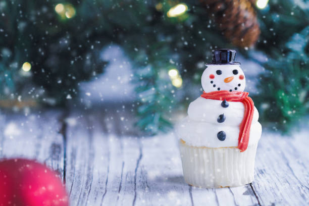 istock Snowman Christmas Cupcake Two Snowman Christmas Cupcakes 1283673991