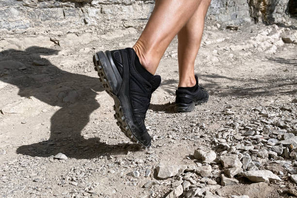 istock close up legs man in trekking shoes 1283674776