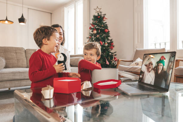 istock Boys opening Christmas gifts while talking with grandparents 1283674900
