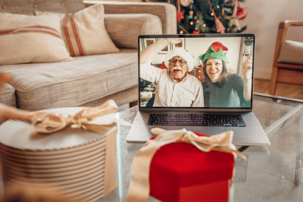 istock Boys opening Christmas gifts while talking with grandparents 1283674906