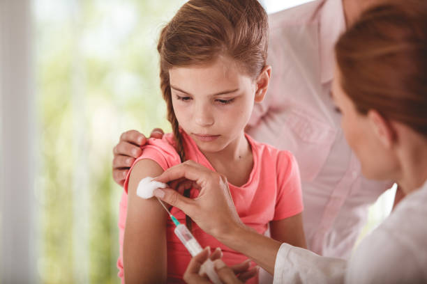 istock Vaccination jab for a girl in pink clothes 1283676077