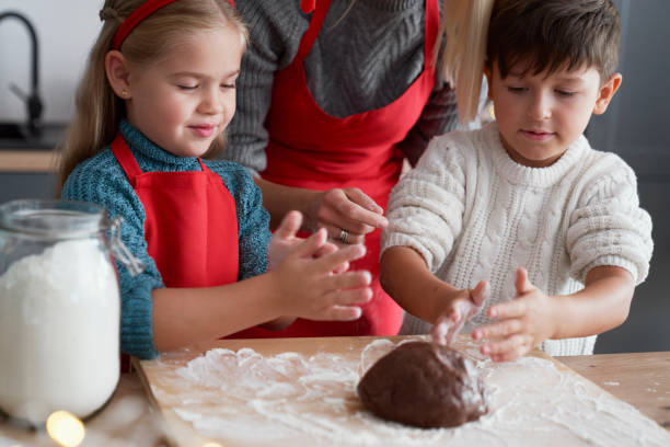 istock Children as great helpers in baking gingerbread cookies 1283676472