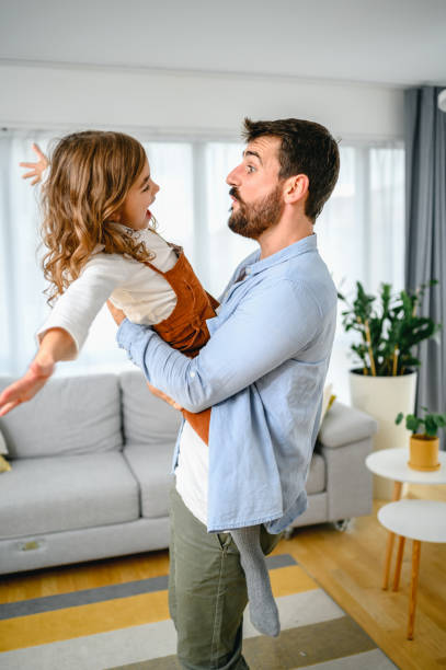 istock Happy dad and daughter dance have fun at home 1283676757