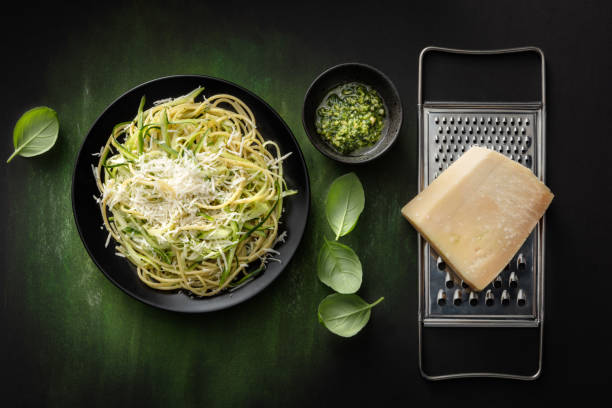 italian food: spaghetti pesto with zucchini still life - recipe ingredient grater cheese grater imagens e fotografias de stock