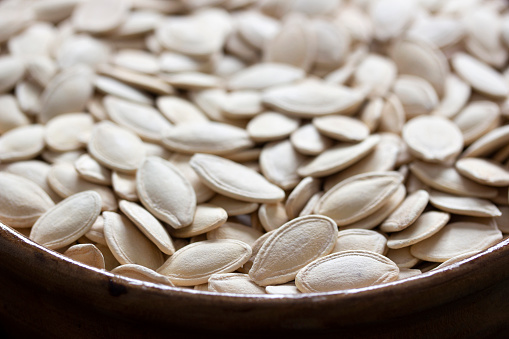 Fresh pumpkin seeds background. Close-up.