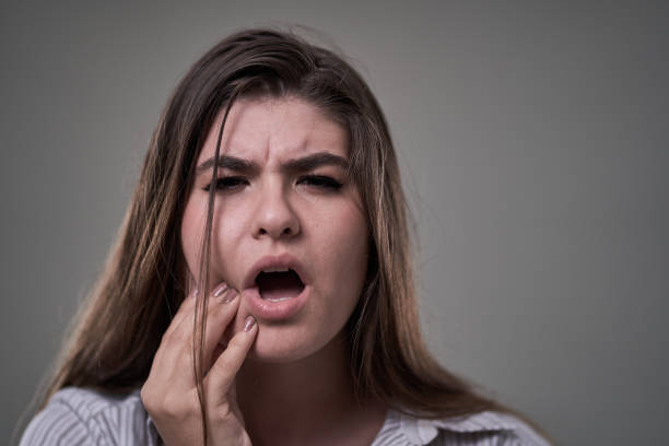 istock Young woman with tooth ache, in severe pain 1283677893