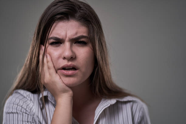 istock Young woman with tooth ache, in severe pain 1283678323
