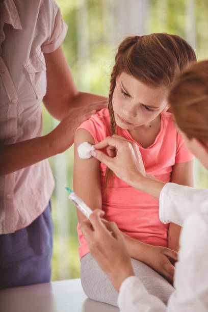 istock Vaccination shot for a girl 1283678365