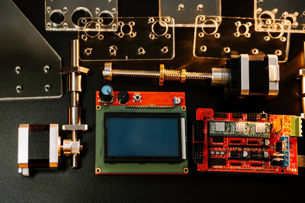 istock a set of different parts for a laser machine on a black background, orange illumination, flat lay. open-source hardware and software board for controlling the machine and v slot aluminum profile lies 1283678620