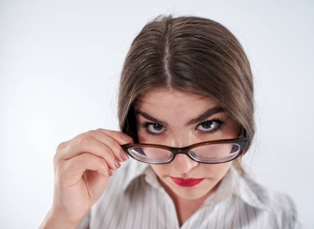 istock Mistrustful businesswoman looking over spectacles 1283678681