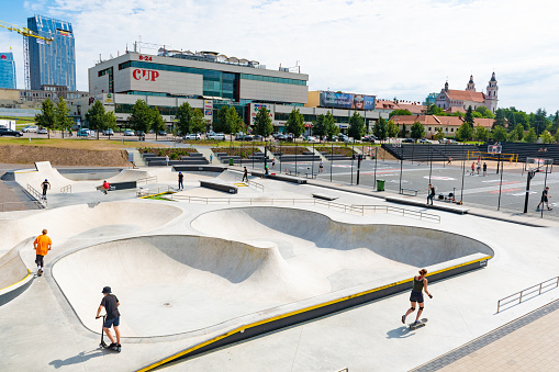 Vilnius, Lithuania - July 20 2020: New skateboard park, skate park, skating rink in the city center with kids or children playing