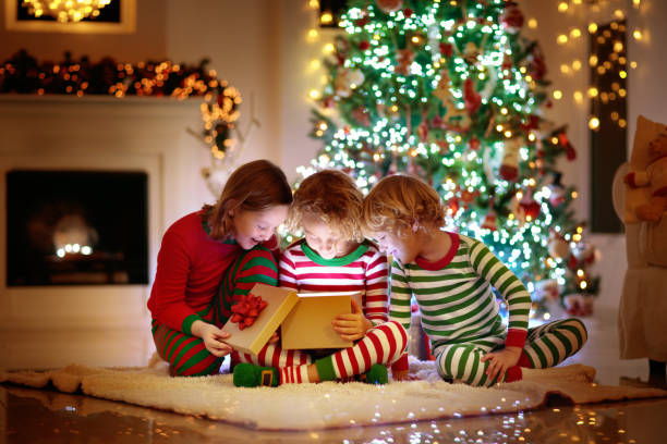 istock Child at Christmas tree. Kids at fireplace on Xmas 1283680168