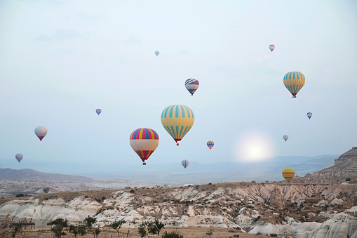 Hot air balloons flying over the valley at Cappadocia ,Travel destination in Turkey