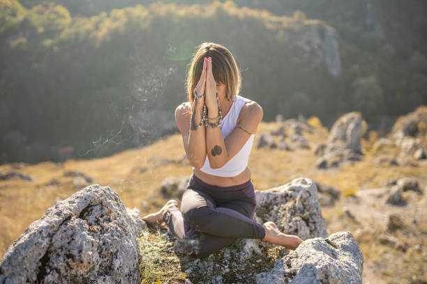 istock Beautiful woman meditating in the nature 1283680498