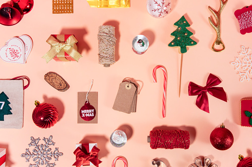 Christmas related objects and ornaments  flat lay on beige background