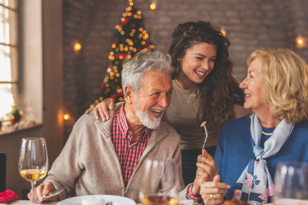 istock Daughter hugging her parents during Christmas dinner 1283681014