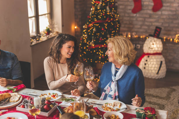 istock Mother and daughter making a toast over Christmas dinner 1283681377