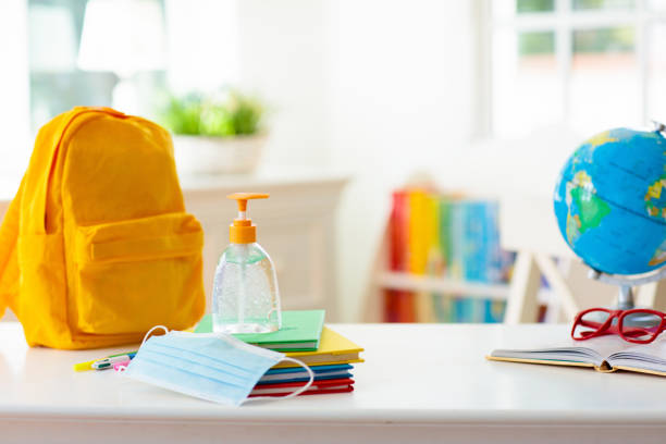 istock Backpack of school child. Face mask and sanitizer. 1283681404