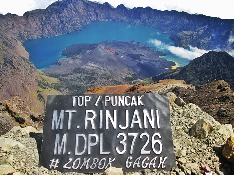 view from the top of Mount Rinjani with a wide stretch of Segara Anak Lake