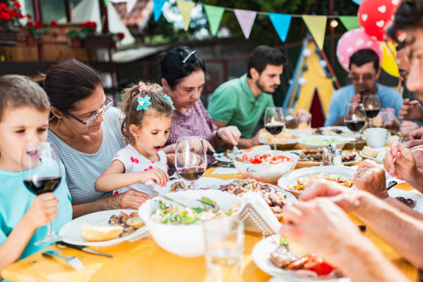 istock Family and friends enjoying BBQ in front yard 1283681991