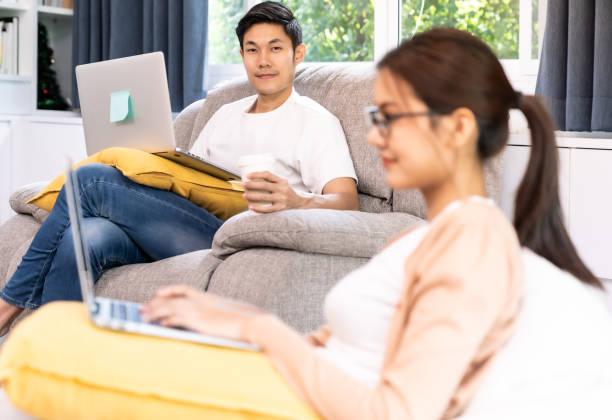 istock Quarantine couple working from home with laptop 1283682146