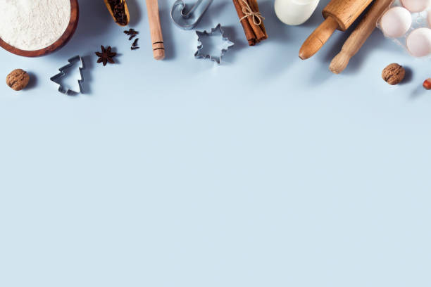 Holiday Baking Ingredients Background Holiday baking ingredients in frame composition on soft blue background walnut cookies stock pictures, royalty-free photos & images