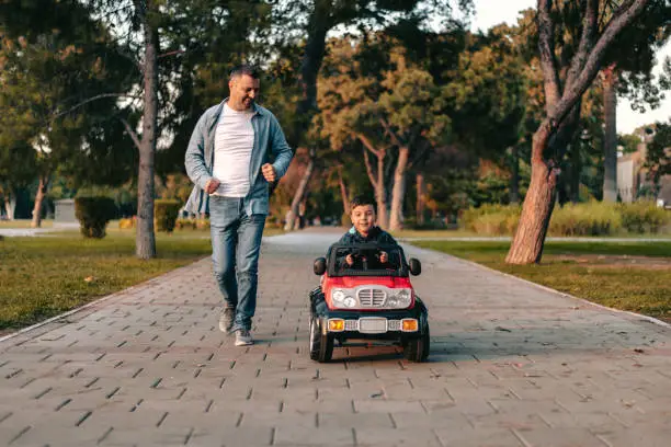 Photo of Father and son playing in the park