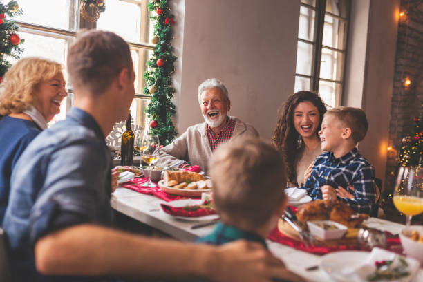 istock Family celebrating Christmas over dinner 1283682579
