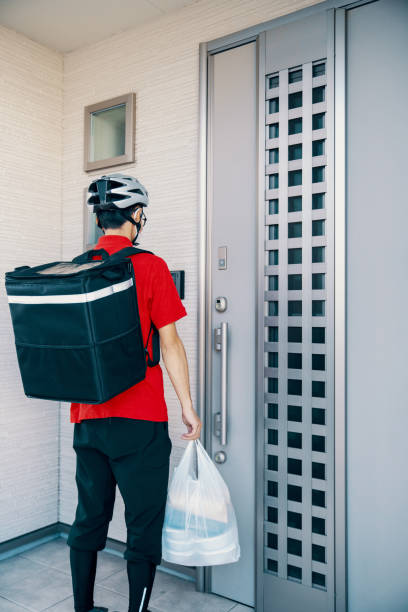 istock Man delivering food by bicycle during a global pandemic 1283682673