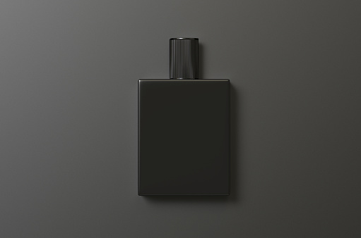 A bottle of aftershave with a black background and shadow