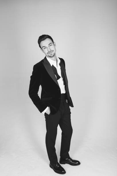 istock Studio portrait of a young man in a tuxedo against plain studio background 1283684547