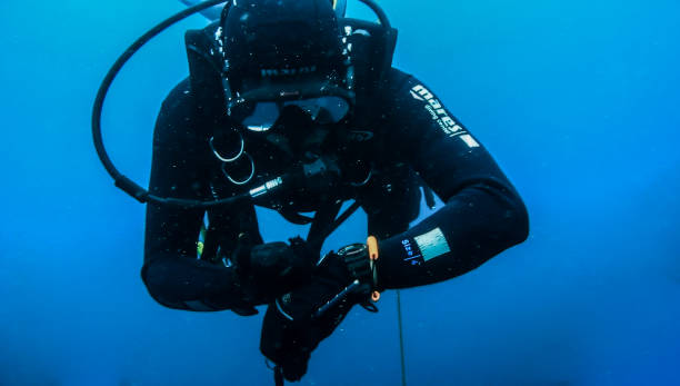 Indonesia-Scientific Exploration-Divers-Underwater Backscatter Localization Shows Indonesian divers conducted a safety stop after diving at the MV Boelongan shipwreck, a depth of 25 meters in Mandeh, Pesisir Selatan Regency, West Sumatra Province, Indonesia. An underwater navigation system powered by sound. The new approach could spark an era of battery-free ocean exploration, with applications ranging from marine conservation to aquaculture. getty image stock pictures, royalty-free photos & images