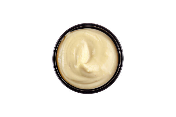 istock Sauce garlic in a plastic disposable dish on a white background, top view. Isolated 1283685399