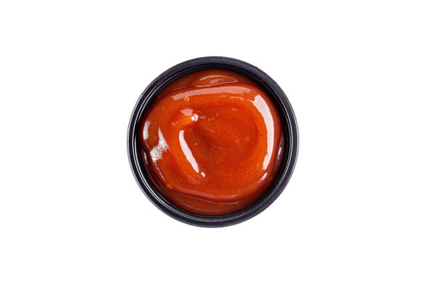 istock Sauce sweet and sour in a plastic disposable dish on a white background, top view. Isolated 1283685401
