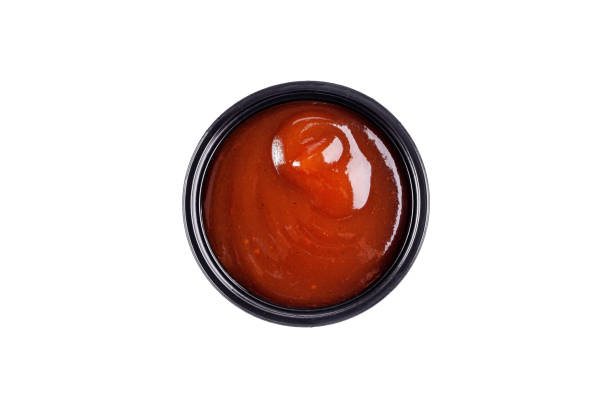 istock Sauce ketchup in a plastic disposable dish on a white background, top view. Isolated 1283685406