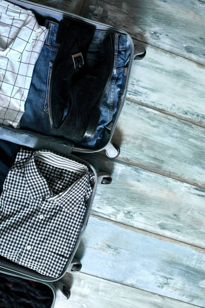 istock Packing suitcase at home with business man items, stuff 1283685767