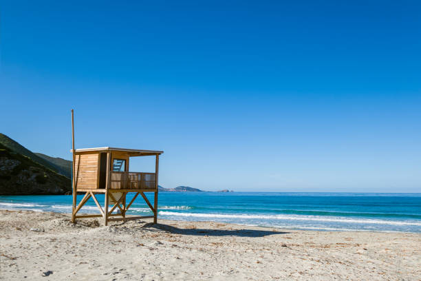 Lifeguard tower and turquoise Mediterranean sea at Ostriconi beach in the Balagne region of Corsica
