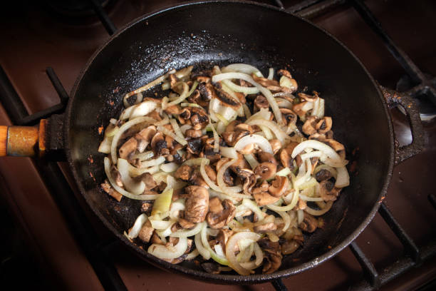istock Champignons frying on the pan with onion 1283687559