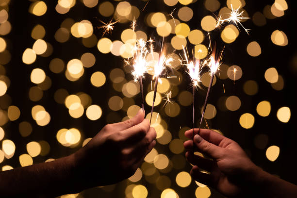 istock Close up of two people's hands with sparklers burning in them 1283687607