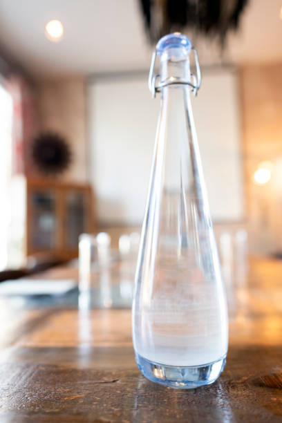 istock Close up glass water bottle on table 1283687809
