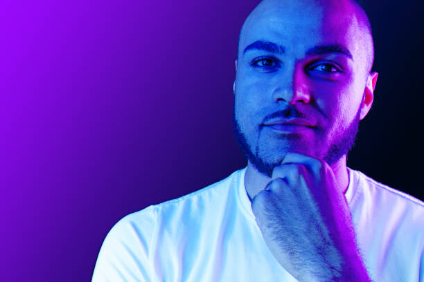 istock Serious thoughtful black  guy portrait in neon light 1283688397