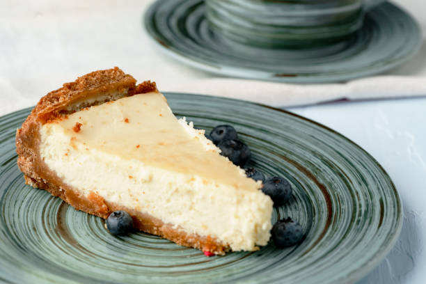 istock Piece of classic cheesecake on green plate 1283689625